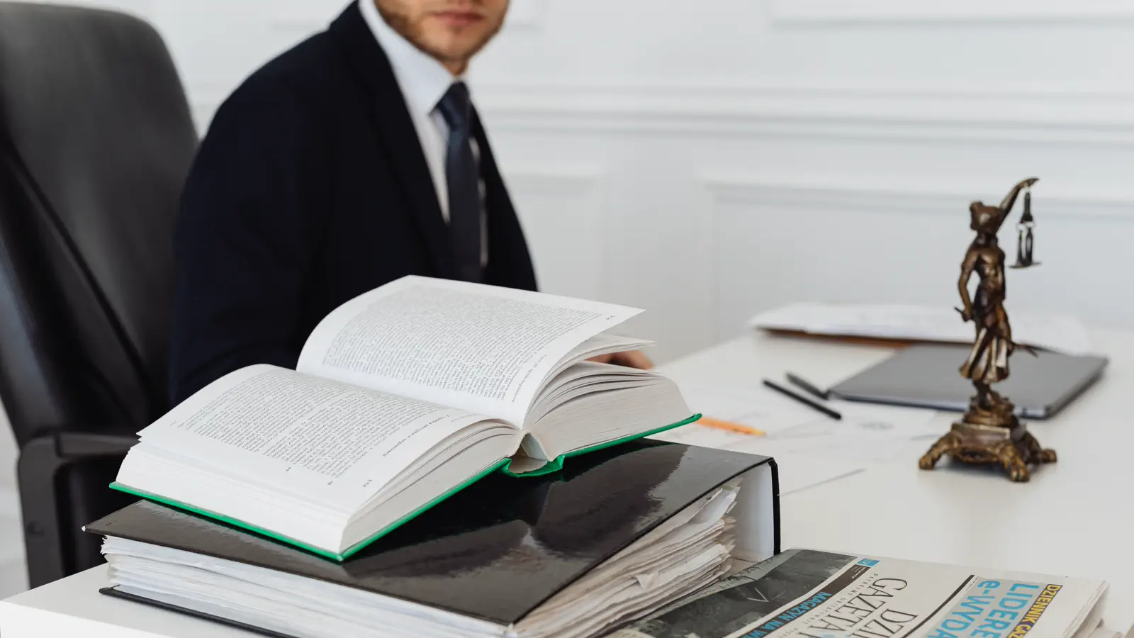 Open law book and organized case files on an office desk