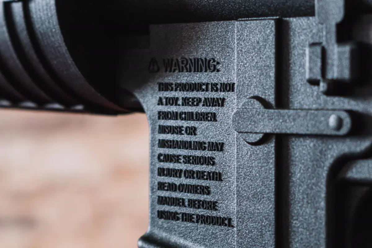 Close view of a safety warning molded into a firearm