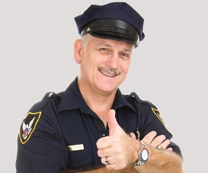 A smiling police officer giving you a thumbs up!