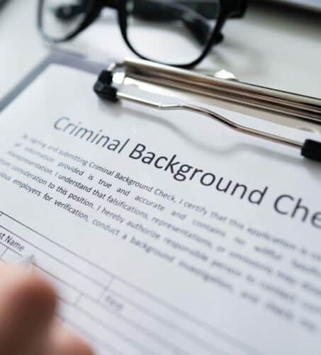 Hand Filling Criminal Background Check Application Form