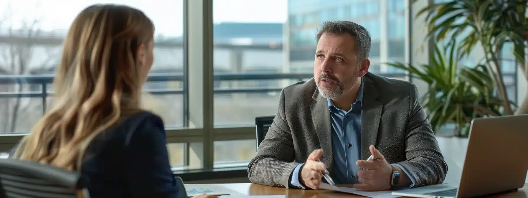 a focused, professional setting showcasing a serious discussion between a client and a dui attorney in a sleek office, with legal documents and a laptop open on the table, highlighting the importance of understanding legal costs and agreements.
